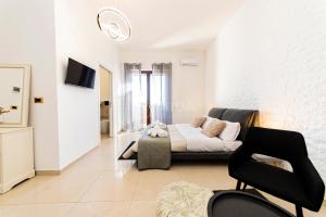 a living room with a couch and a chair at Dimora Due Mari in Salice Salentino