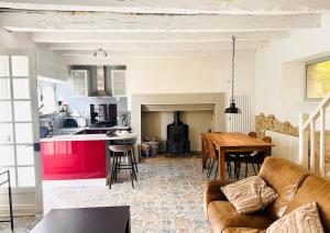 a living room with a couch and a table at Les Deux Canards Perdus in Rouffignac Saint-Cernin +10 photos
