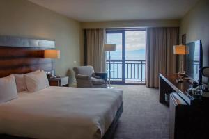 a hotel room with a bed and a balcony at Radisson Hotel Puerto Varas in Puerto Varas