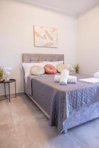 a bedroom with a bed with pillows on it at Peace Home Trikala in Tríkala