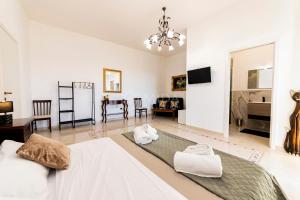 a large white room with a bed and a table at Dimora Due Mari in Salice Salentino
