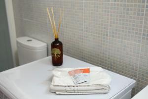 a vase sitting on top of a toilet in a bathroom at L'arco Sul Mare in Balestrate +27 photos