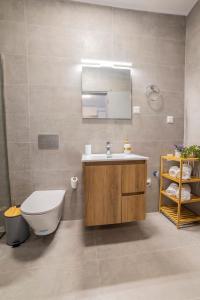 a bathroom with a sink and a toilet and a mirror at Peace Home Trikala in Tríkala +45 photos