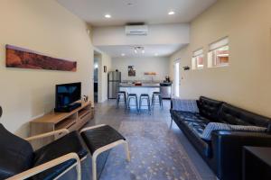 a living room with a couch and a table with chairs at The Kayenta Flat in Moab UT in Moab