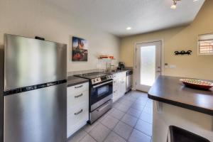 a large kitchen with a stainless steel refrigerator at The Kayenta Flat in Moab UT in Moab