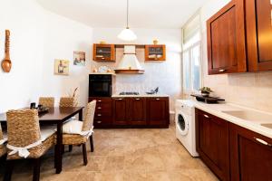 a kitchen with a table and a washing machine at Dimora Due Mari in Salice Salentino