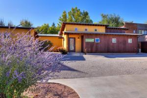 an orange building with a driveway in front of it at The Kayenta Flat in Moab UT in Moab