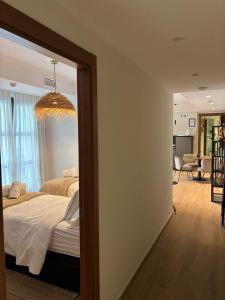 a bedroom with a bed and a chandelier at Zazz Estepona in Estepona