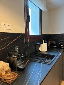 a kitchen with a black counter top with a toaster at Zazz Estepona in Estepona +19 photos