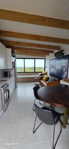 a kitchen and living room with a table and chairs at Fynbos N Sea in Gansbaai