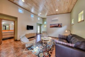 a living room with a leather couch and chairs at The Wingate Flat 4 in Moab