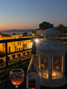 a bottle of wine and a glass on a table at Artelie apartment in Kyparissia +4 photos