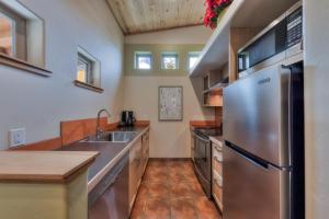 a kitchen with a stainless steel refrigerator and a sink at The Wingate Flat 4 in Moab