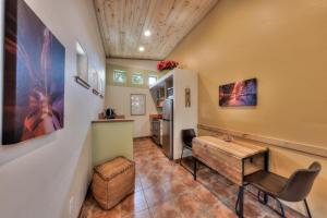 a living room with a table and a refrigerator at The Wingate Flat 4 in Moab