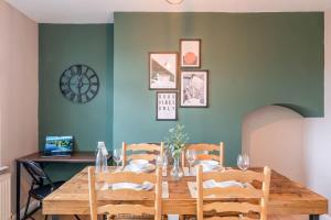 a dining room with a wooden table and chairs at Spacious 3-Bed with parking NEAR NEC & BHX AIRPORT in Allesley