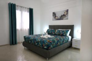 a bedroom with a bed with a stuffed animal on it at L'arco Sul Mare in Balestrate