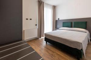 a bedroom with a bed and a large window at Terre del Mandrolisai in Sorgono