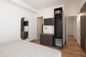 a bedroom with a bed and a dresser and a mirror at Terre del Mandrolisai in Sorgono