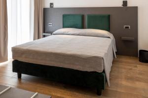 a bedroom with a large bed with a headboard at Terre del Mandrolisai in Sorgono
