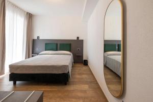 a bedroom with two beds and a mirror at Terre del Mandrolisai in Sorgono +36 photos