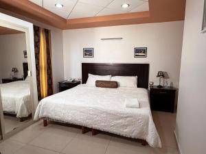 a bedroom with a large bed with white sheets at Rolovi Hotel Xalapa Centro in Xalapa +66 photos
