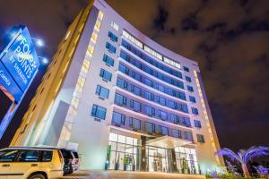 a building with a car parked in front of it at Four Points by Sheraton Cuenca in Cuenca