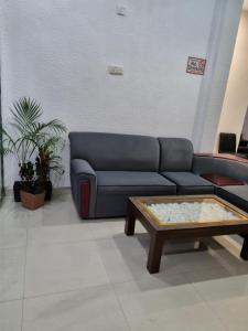 a living room with a couch and a coffee table at Wings Hotel & Hostel in Trincomalee