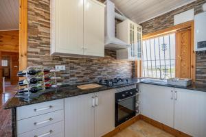 a kitchen with white cabinets and a counter top at Rustic Villa Retreat in Pinoso
