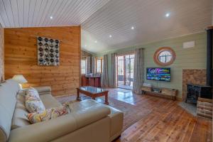 a living room with a couch and a television at Rustic Villa Retreat in Pinoso