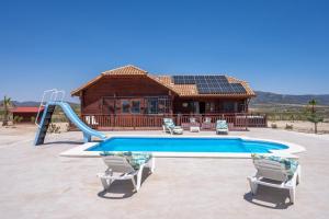 a house with a swimming pool and a house at Rustic Villa Retreat in Pinoso