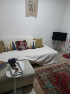 a living room with a couch and a table at Soul in Bela Crkva