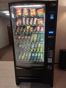 a refrigerator filled with lots of soda and sodas at Terres de France - Appart'Hotel Quimper Bretagne in Quimper