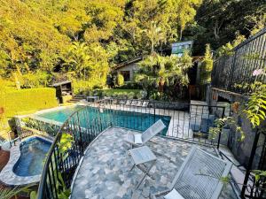 a balcony view of a swimming pool with a table and chairs at Private Room With Jacuzzi, Pool, and Sauna. in San Lucas Tolimán