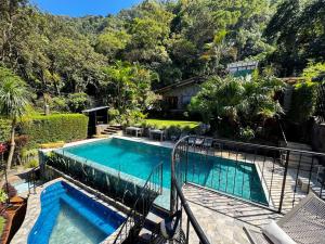 a swimming pool in a yard with a house at Private Room With Jacuzzi, Pool, and Sauna. in San Lucas Tolimán
