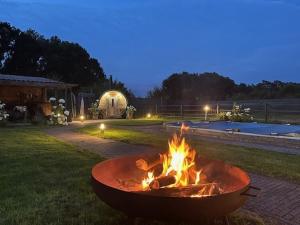 a fire pit in the middle of a yard at night at Lucky luke's hideaway in Heibloem