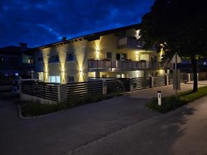 a building with lights on the side of it at night at Zum Löwen Apartments in Reutte