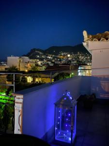 a blue lighted lantern on top of a building at night at Artelie apartment in Kyparissia