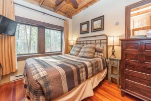 a bedroom with a bed and a dresser and a window at Tolson Cabin by Railey Vacations in Oakland