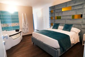 a bedroom with a large bed and a bath tub at Rooms Vesuvio Est in Striano +50 photos