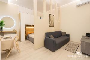 a living room with a couch and a bedroom at Severino Sweet Home Casa Vacanze in Mercato San Severino +30 photos