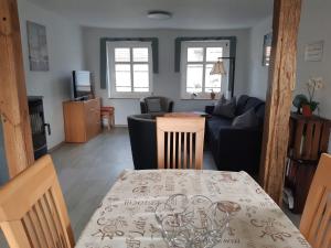 a living room with a table and a couch at Ferienhaus Paries in Nitzow