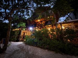 a resort building with lights on it at night at Thani Ecobeach Barú in Playa Blanca