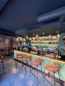 a bar with orange stools in a restaurant at Zazz Estepona in Estepona