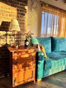 a blue couch in a living room with a table at Studio54 Stunning View plus Free Parking in Veliko Tŭrnovo
