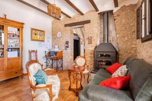 a living room with a couch and a fireplace at La iaia Merce in L'Aldea