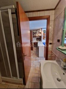 a bathroom with a toilet and a sink and a door at Dolce Vista in Passo del Tonale