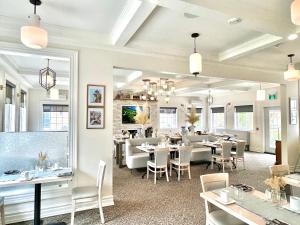 a dining room with tables and chairs in a restaurant at Tattingstone Inn in Wolfville