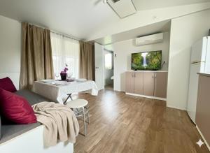 a living room with a couch and a table at Mobile Homes Relax Park Umag in Umag