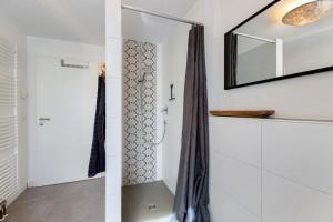 a bathroom with a shower and a mirror at Fewo Spectrum in Überlingen +31 photos