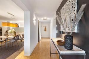a dining room and kitchen with a vase on a table at Fewo Spectrum in Überlingen